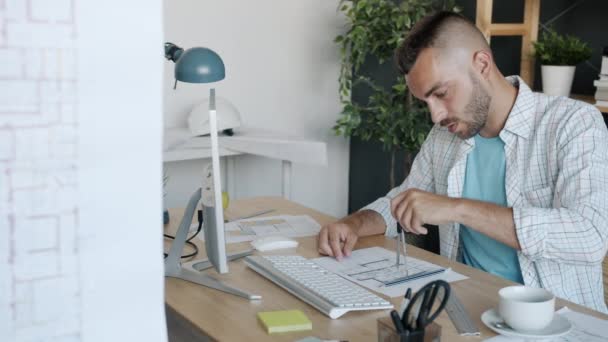 Ritratto di affascinante architetto freelance che misura il piano di costruzione lavorando a tavola a casa — Video Stock