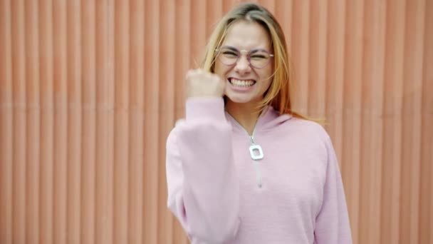 Slow motion portrait of joyful girl blonde expressing happiness and laughing outdoors — Stock Video