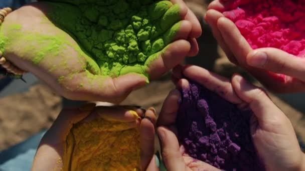 Primo piano di mani maschili e femminili che tengono la pittura a polvere colorata durante il festival di Holi — Video Stock