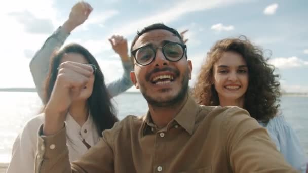 Point of view portrait of happy friends multiracial group dancing and singing laughing having fun on beach — Stock Video