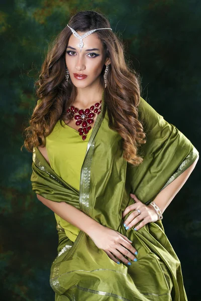 Young pretty woman in green indian dress — Stock Photo, Image