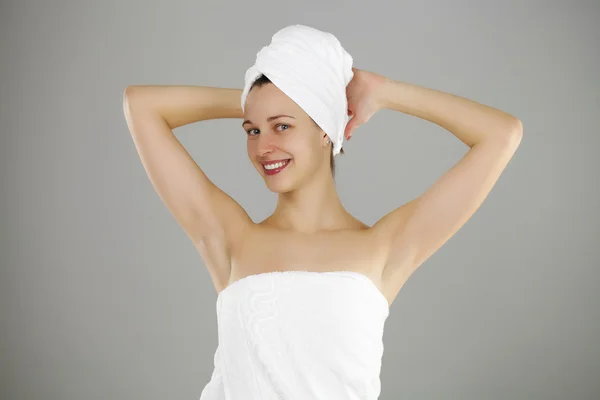 Beautiful young woman posing in white towel — Stock Photo, Image