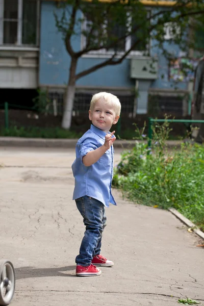 Blonde baby boy in  blue shirt and jeans — Stock Photo, Image