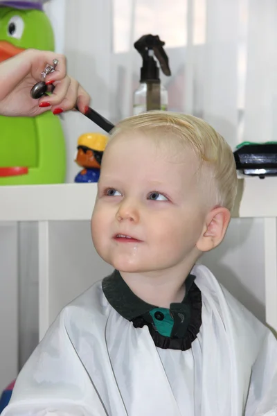 Blonde Petit garçon coupé leurs cheveux dans un salon de coiffure pour enfants — Photo