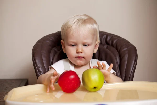 Two year baby boy sitting at the dinner table — Stock Photo, Image