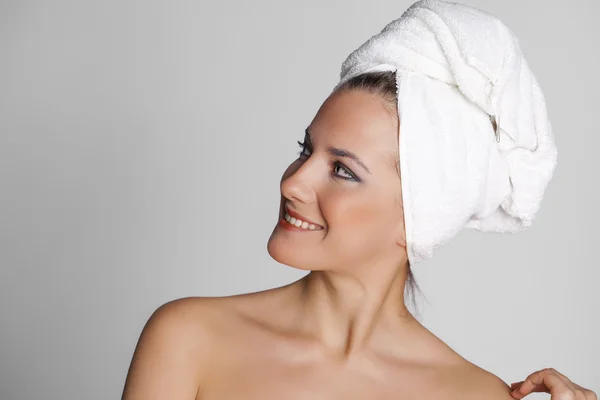 Beautiful young woman posing in white towel — Stock Photo, Image