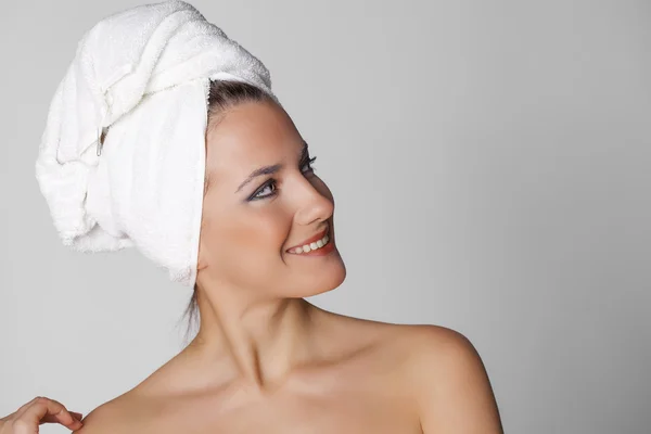 Beautiful young woman posing in white towel — Stock Photo, Image