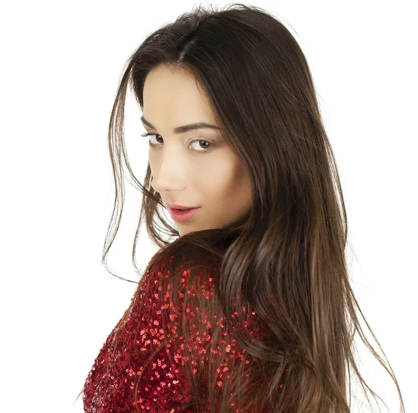 Beautiful young model in red dress posing in the studio on a whi — Stock Photo, Image