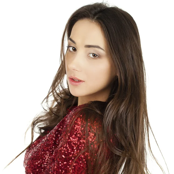 Beautiful young model in red dress posing in the studio on a whi — Stock Photo, Image