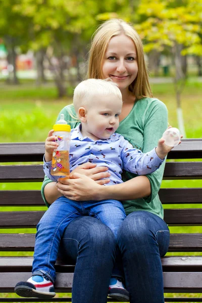 Young mother holds on hands of his two year old son — Stock Photo, Image