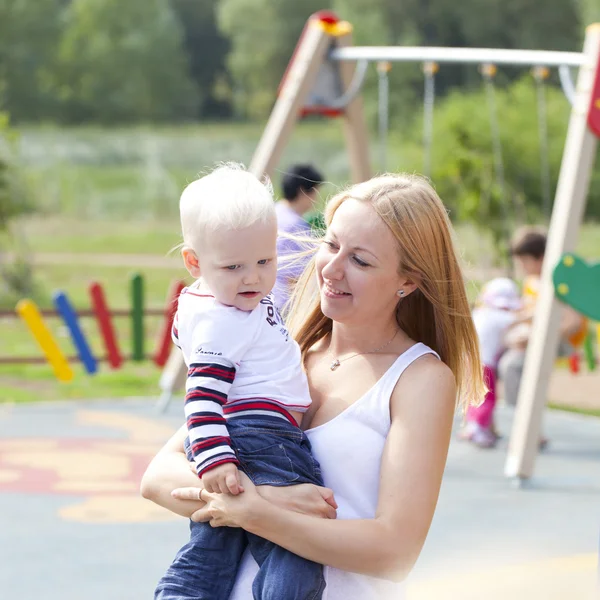 Young mother holds on hands of his two year old son — Stock Photo, Image