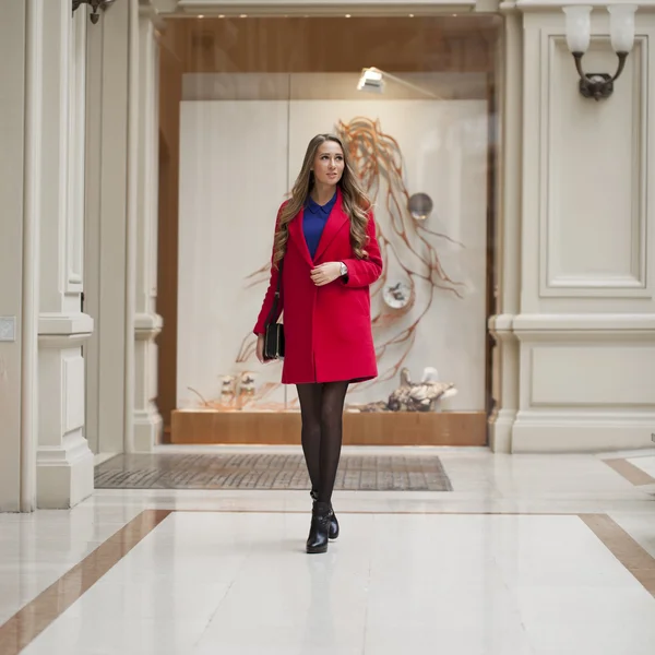 Happy beautiful blonde woman in red coat — Stock Photo, Image