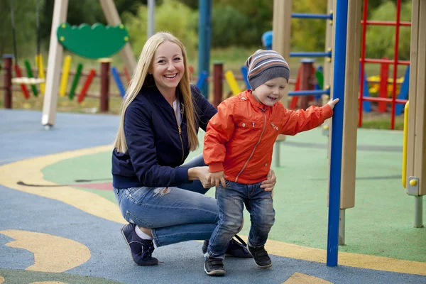 Happy mother and baby boy playing on the playground — Stock Photo, Image