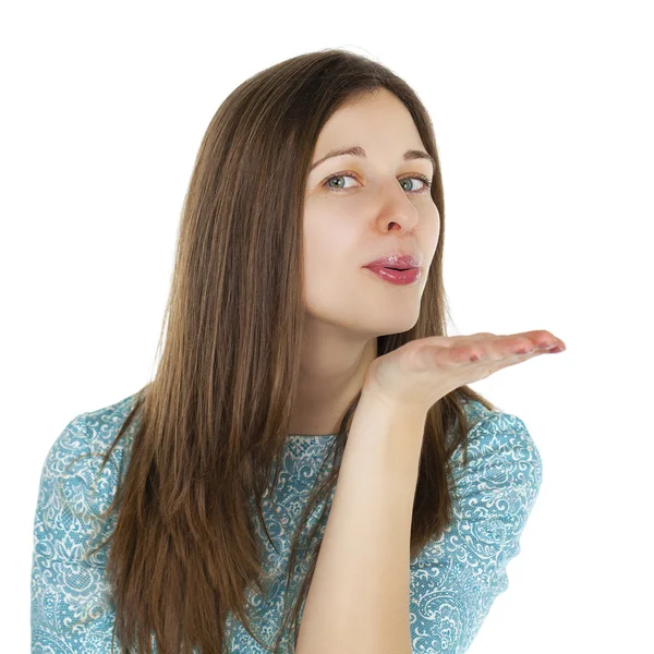 Young brunette woman blowing while sending an air kiss — Stock Photo, Image