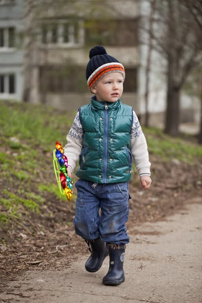 Baby boy in green jaket and blue jeans — Stock Photo, Image