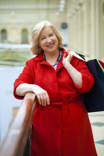 Mature happy woman with shopping bags — Stock Photo, Image