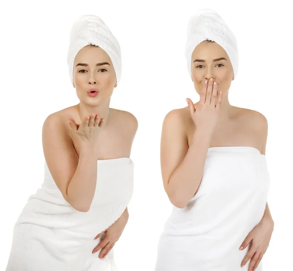 Young  woman in white towel blowing while sending an air kiss — Stock Photo, Image