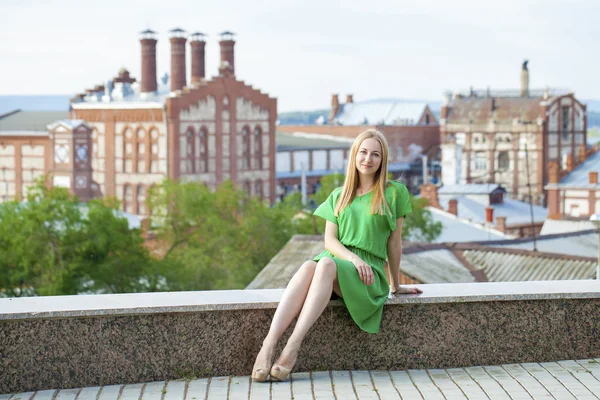 Jeune belle femme en robe verte posant en plein air sous le soleil nous — Photo