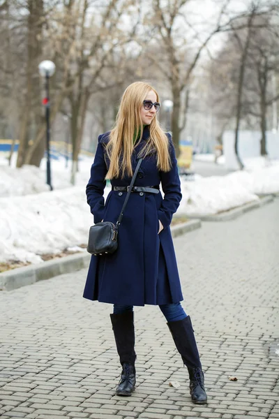 Young woman in a blue coat — Stock Photo, Image