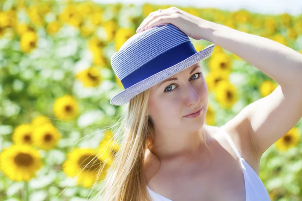 Portrait of a beautiful young blonde woman in a white dress on a — Stock Photo, Image