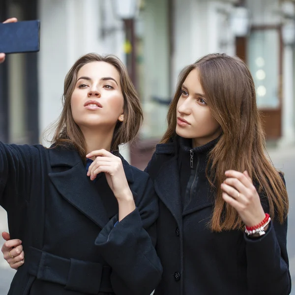 Close Up portrait of two friends in a black coat — Stock Photo, Image