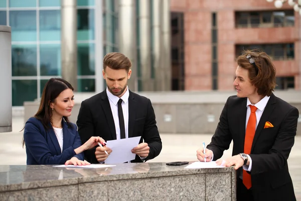 Business people sign a contract