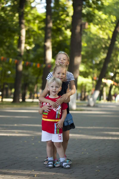 Blonde Little boy and three older cousins sisters — Stock Photo, Image