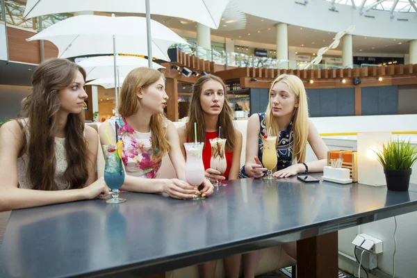 Nahaufnahme von vier attraktiven jungen Frauen, die Cocktails im Shopp trinken — Stockfoto