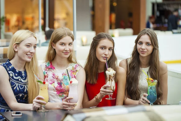Nahaufnahme von vier attraktiven jungen Frauen, die Cocktails im Shopp trinken — Stockfoto
