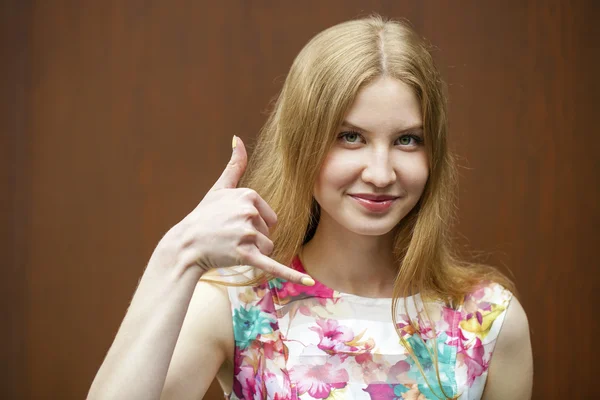 Beautiful woman making a call me gesture — Stock Photo, Image