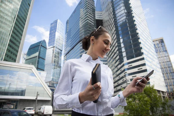 Young brunette woman calling by phone Stock Picture