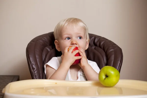 Two year baby boy sitting at the dinner table — Stock Photo, Image