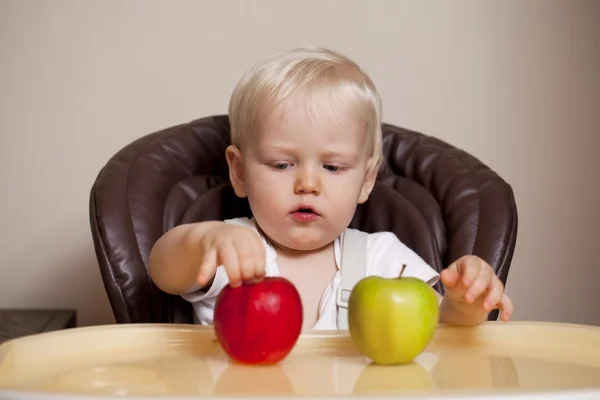 Two year baby boy sitting at the dinner table — Stock Photo, Image