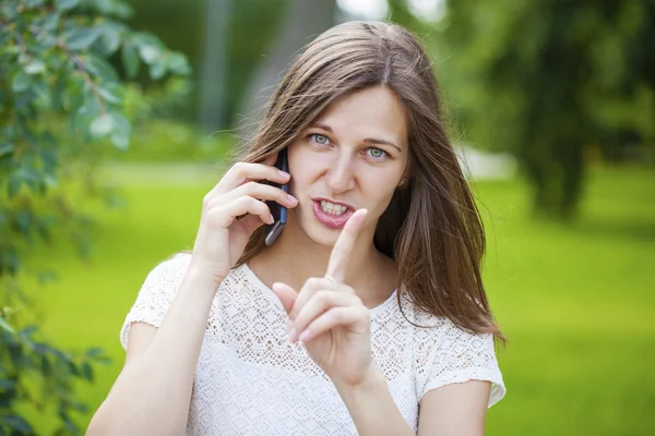 携帯電話で話す美しい濃い髪若い女性の肖像画 — ストック写真