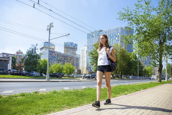 Young beautiful woman in black short walking on the summer stree — Stock Photo, Image