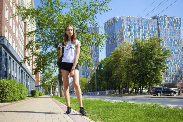 Young beautiful woman in black short walking on the summer stree — Stock Photo, Image