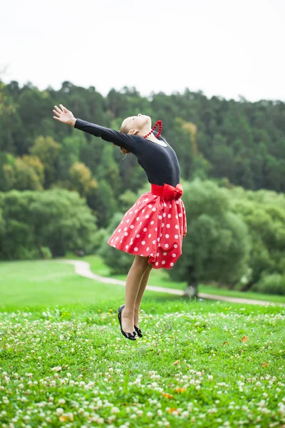 Little girl in a beautiful dress dancing — Stock Photo, Image