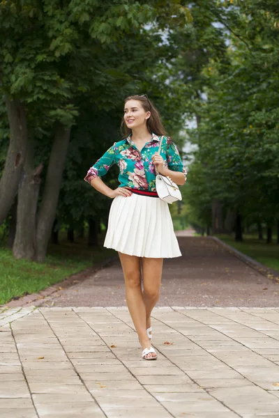 Young brunette woman in white skirt — Stock Photo, Image