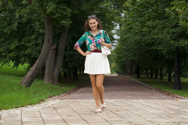 Young brunette woman in white skirt — Stock Photo, Image