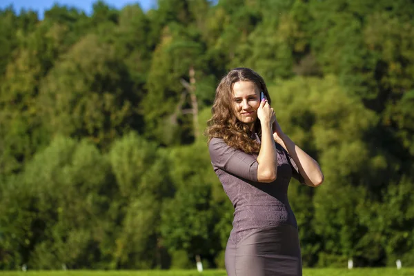 Vacker ung brunett kvinna ringer via telefon — Stockfoto