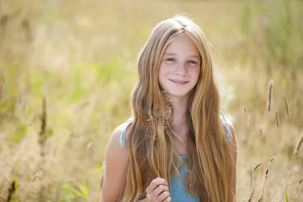 Красива молода маленька дівчинка біжить літнє поле — стокове фото