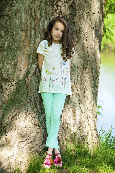 Little Girl on tree trunk — Stock Photo, Image