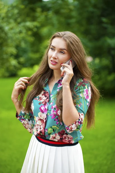 Portret van mooie donkere donkerharige jonge vrouw die spreken op mobiele telefoon — Stockfoto