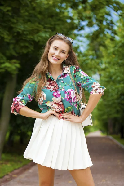 Young brunette woman in white skirt — Stock Photo, Image