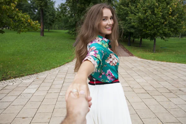 Follow me, Beautiful young woman holds the hand of a man — Stock Photo, Image