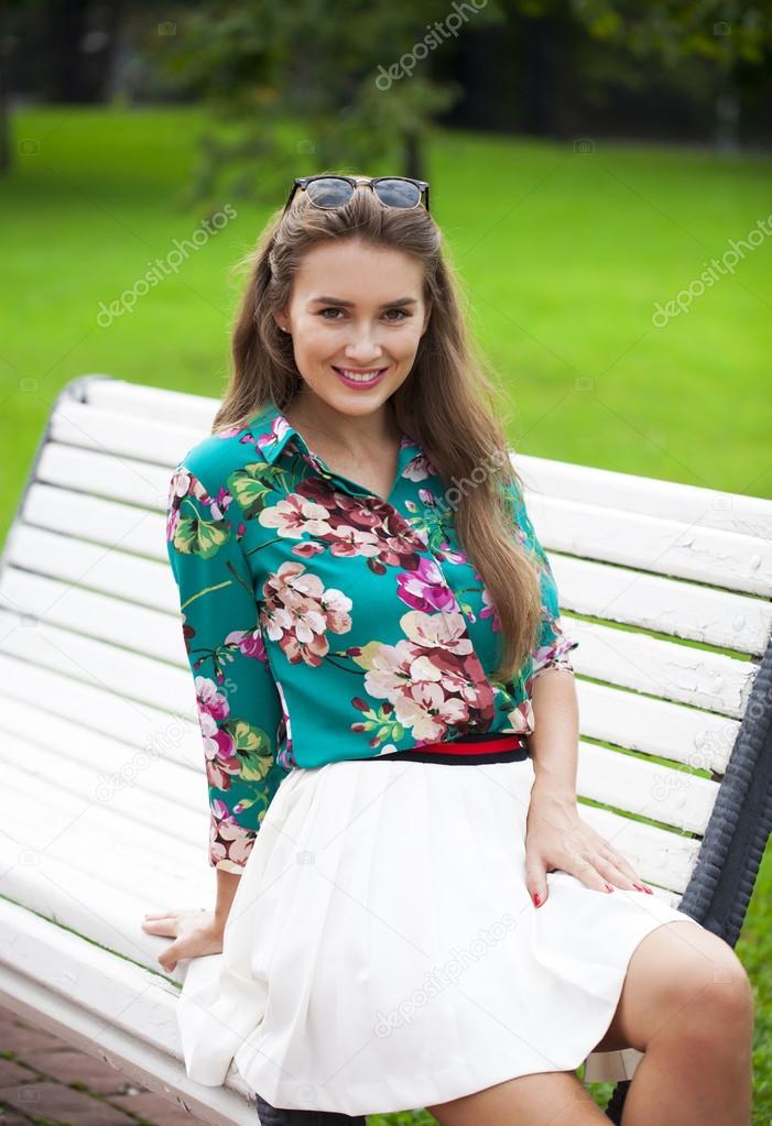 Young brunette woman in white skirt