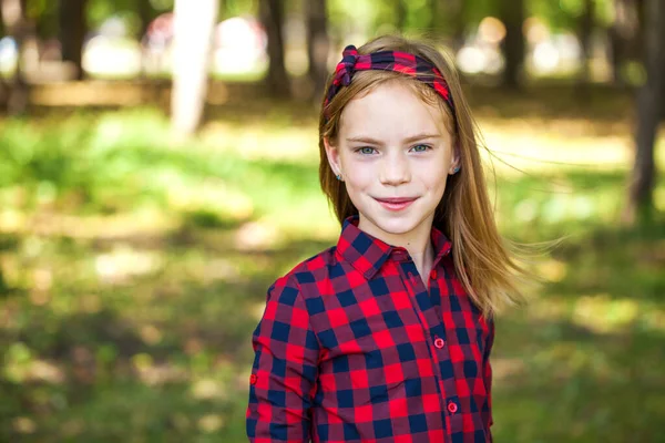 一个红头发小女孩穿着红格子花衬衫的画像 — 图库照片