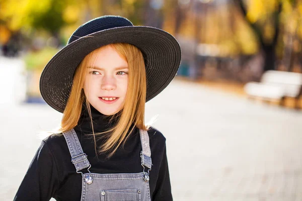 秋天的公园里 一个戴着黑色帽子的红头发小女孩的画像在散步 — 图库照片