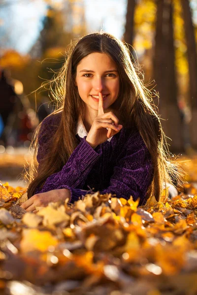 Fiatal Gyönyörű Lány Lila Pulcsiban Fekszik Őszi Leveleken — Stock Fotó