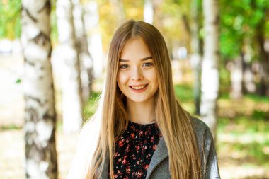 Gri paltolu güzel sarışın bir kadının portresini yakından çek.